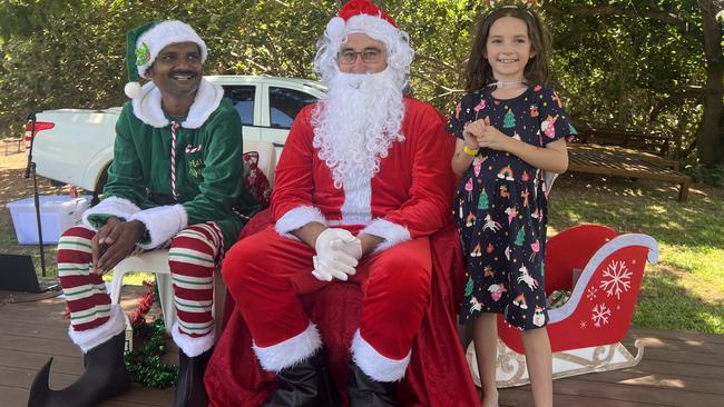 Accompanied by a Little Helper, Santa gatecrashed the CareFlight fundraising party.