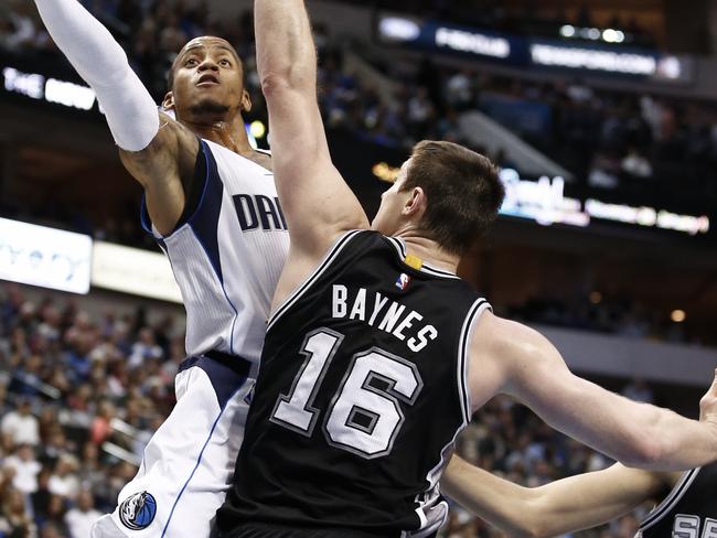 Dallas Mavericks guard Monta Ellis (11) shoots over San Antonio Spurs forward Aron Baynes (16) during the first half of an NBA basketball game, Saturday, Dec. 20, 2014, in Dallas. (AP Photo/Jim Cowsert)