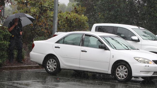 Police inspect the car in which two people were found shot. Picture: Mike Batterham