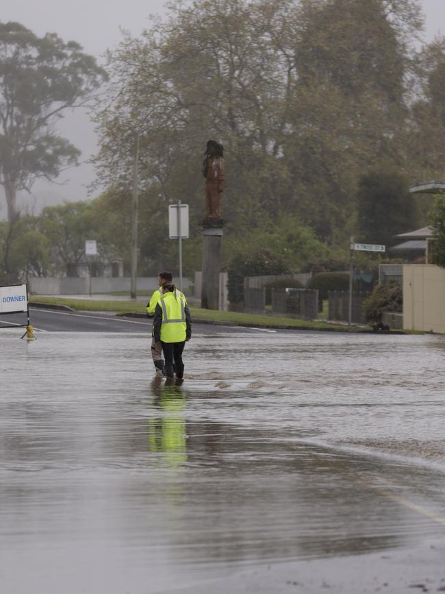 People walk through flood waters in the Main Street of Latrobe. Picture: Grant Viney