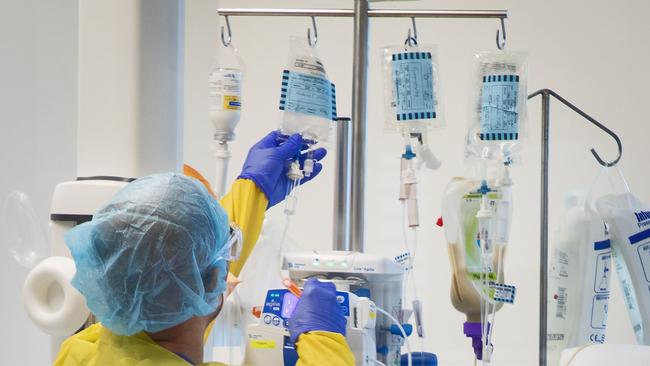 Nurse Franz Brana attends to a Covid-19 patient. In the ICU-C ward. Picture: Chris Pavlich/ The Manly Daily