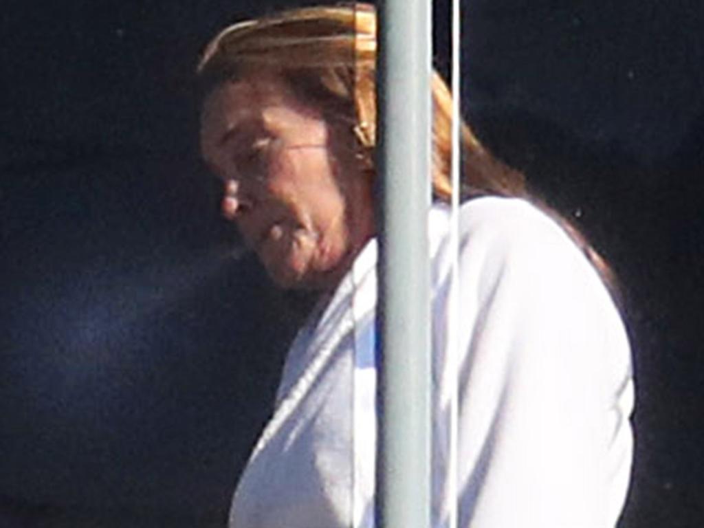 Jenner was seen smoking on her balcony during hotel quarantine. Picture: KHAPGG / BACKGRID