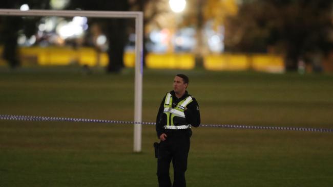 Police at the soccer field in Carlton North. Picture: David Crosling