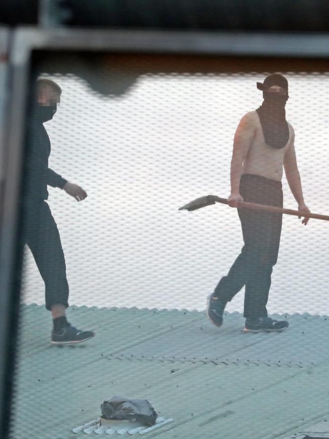 Inmates from the Frank Baxter Juvenile corrections centre Kariong taunt police from the roofs of various buildings. Some are armed with poles tennis rackets ect. Picture: John Grainger