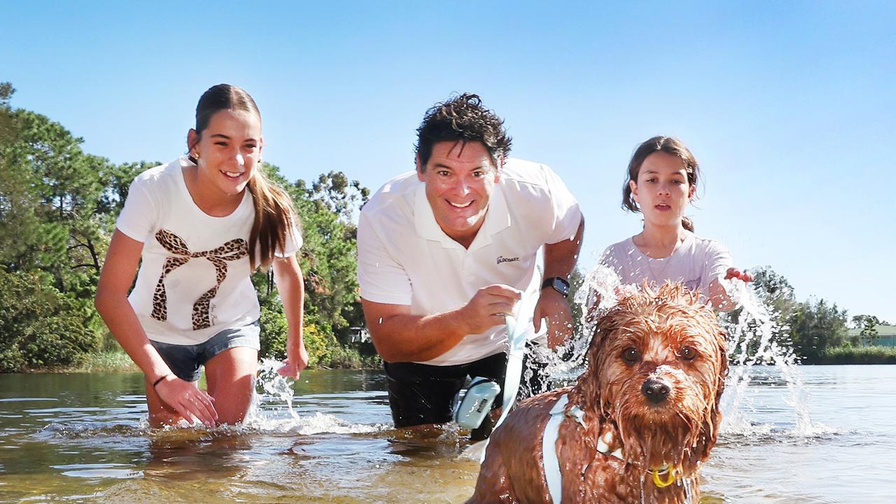 Division 12 councillor Nick Marshall with daughters Ella 12 and Imogen 10 take their Cavoodle Bowie for a paddle to promote a dog swim-run race. Picture: Glenn Hampson.