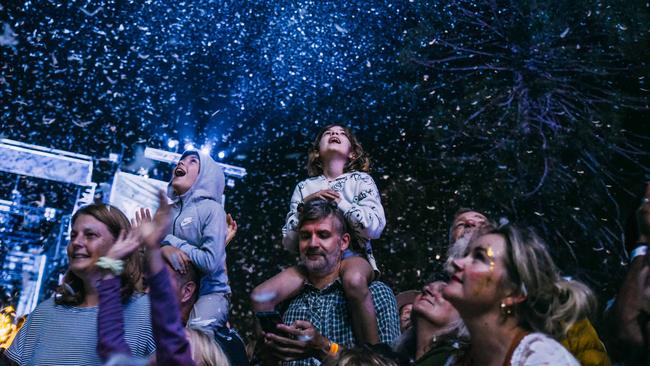 Festivalgoers playing in the feather storm during a performance of Place des Anges. Wade Whitington