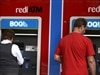 Customers at a Bank of Queensland ATM