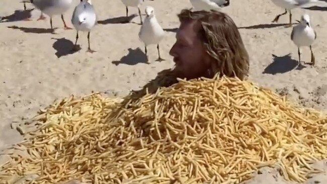 Michael buried himself from the neck down on Surfers Paradise beach. Picture: Instagram