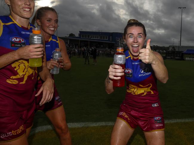 Jess Wuetschner (right) celebrates a Lions win. (AAP Image/Glenn Hunt)