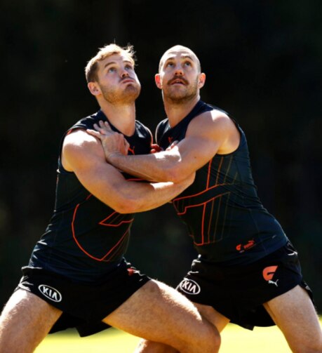 Matthew Flynn wrestles with Shane Mumford at GWS training. Picture: Phil Hillyard