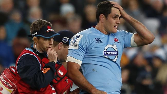 Dave Dennis is helped by medical staff after injuring himself. NSW Waratahs Vs ACT Brumbies Saturday 28th June 2014. Pic: Mitch Cameron