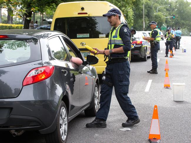 Victoria Police officers breath test drivers on Alexandra Avenue in Melbourne on January 1st, 2015. Picture: Mark Dadswell