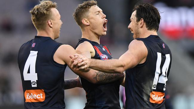 James Harmes, Jake Melksham and Michael Hibberd celebrate a goal.