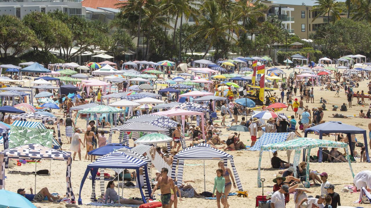 Holiday crowds pack in at Noosa Main Beach. Picture: Lachie Millard