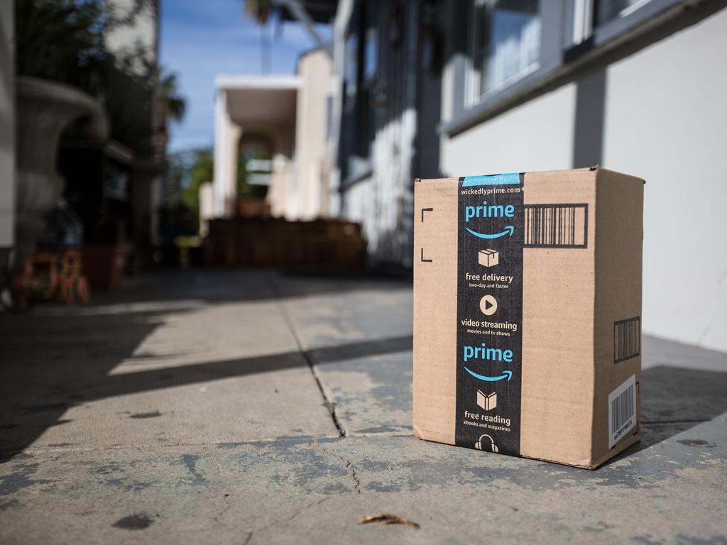 Los Angeles CA, November 11/22/2017: Image of an Amazon packages. Amazon is an online company and is the largest retailer in the world. Cardboard package delivery at front door during the holiday season. shipping package parcel box on wooden floor with protection paper inside. Amazon.com went online in 1995 and is now the largest online retailer in the world.