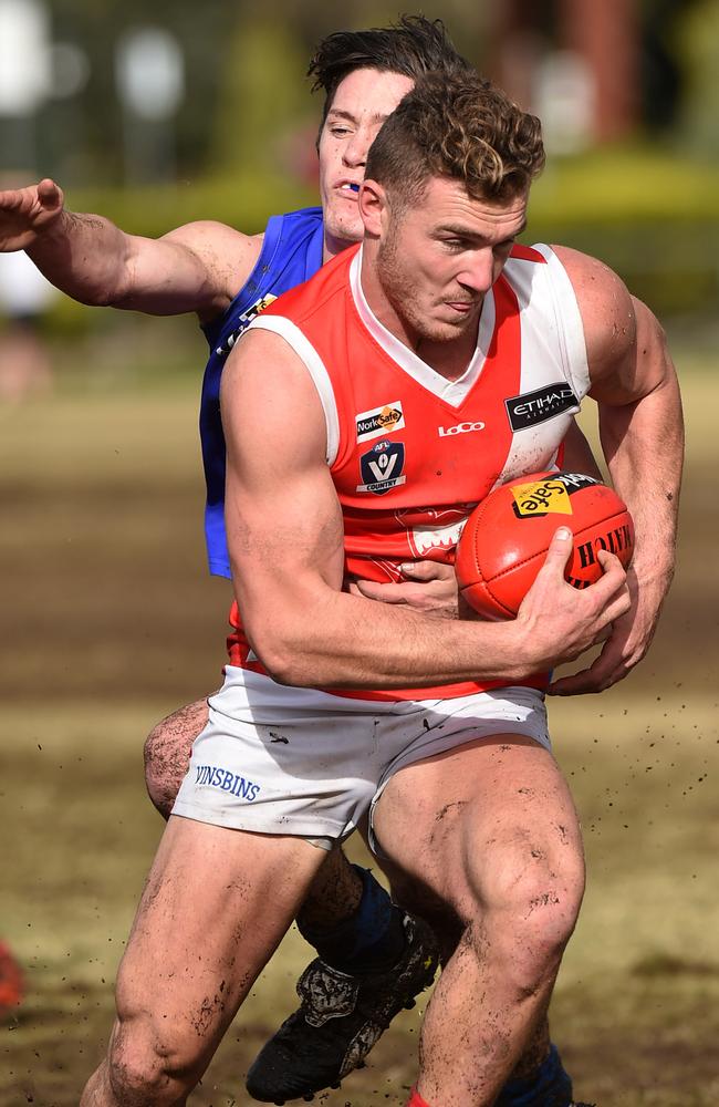 Luke Tapscott bursting through a Hasting tackle. Picture: Christ Eastman