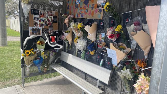 The memorial for Michael Warburton at a bus stop on Kianawah Rd where the Brisbane man was killed in a tragic hit and run crash.