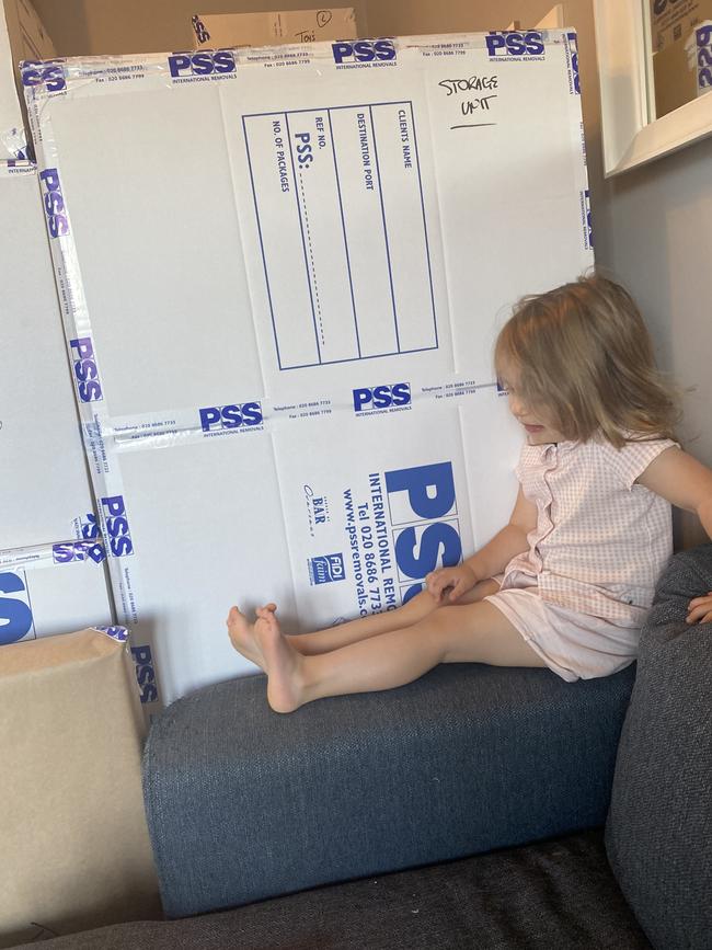 Amelia, 3, beside one of the family's packing cases.