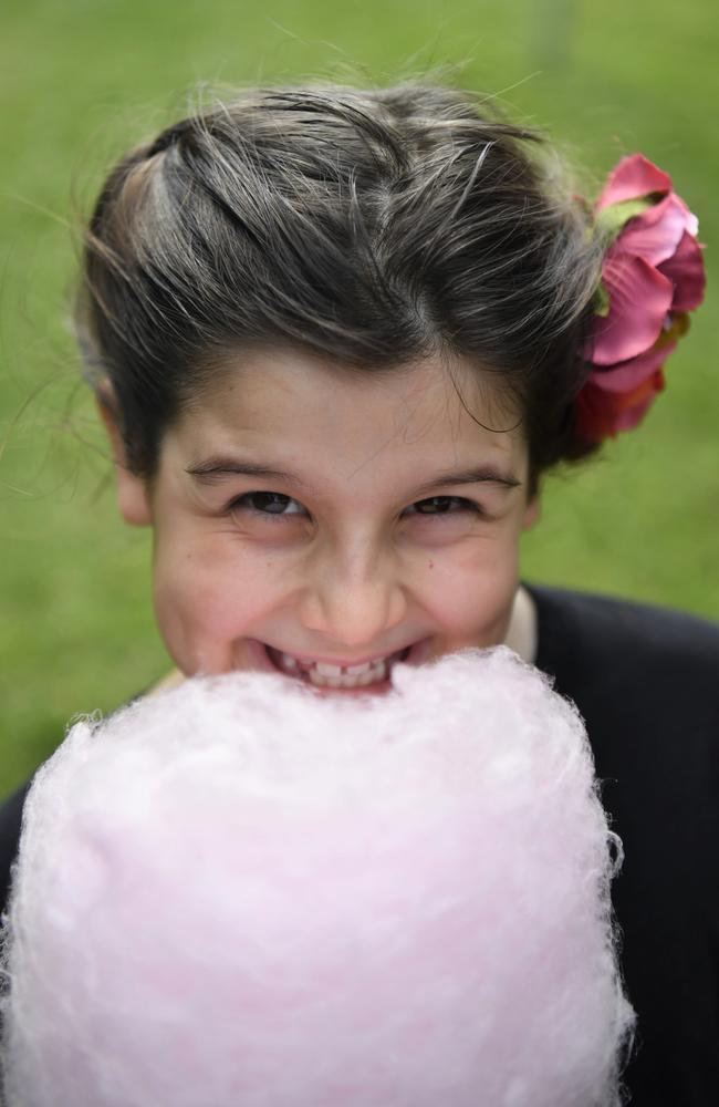 Lucy Tynan, 8, with some fairy floss at the Chief Minister's Cup Day at the Darwin Turf Club on Saturday, July 15.