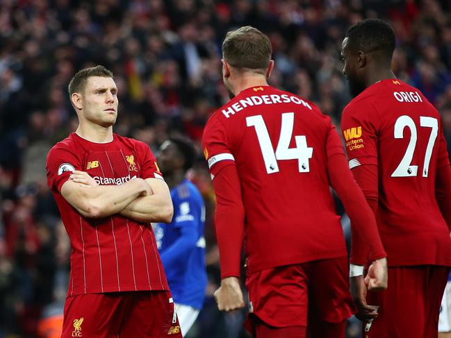 LIVERPOOL, ENGLAND - OCTOBER 05: James Milner of Liverpool celebrates with Jordan Henderson of Liverpool and Divock Origi of Liverpool after he scores his sides second goal from the penalty spot during the Premier League match between Liverpool FC and Leicester City at Anfield on October 05, 2019 in Liverpool, United Kingdom. (Photo by Clive Brunskill/Getty Images)