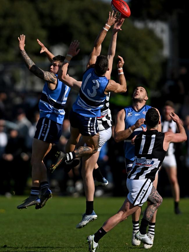 WRFL: Point Cook Centrals and Parkside players fly for the mark. Picture: Andy Brownbill