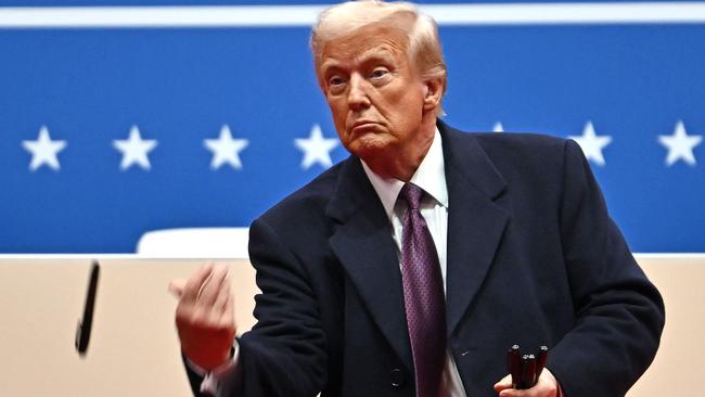 President Donald Trump throws sharpies to the crowd after signing executive orders inside Capital One Arena. Picture: AFP