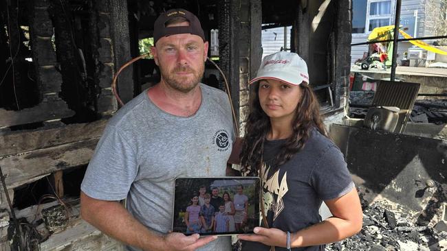 Daniel and Gemma O'Brien with the shards of what's left of their family home after a blaze tore through their house on Sunday. Picture: Luke Kane