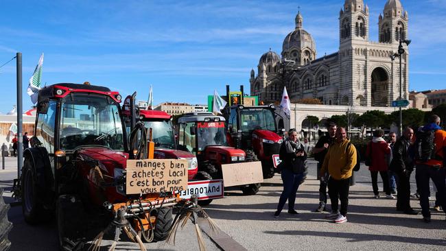 A placard displayed on a French farmer's tractor reads "Eat well, buy local: It's good for you and for us" during a demonstration against the agriculture policy near the Cathedral de la Major in Marseille, on February 19, 2024. Picture: AFP