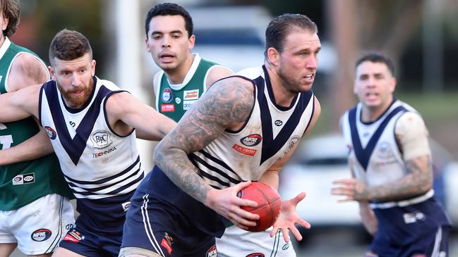 NFL Football: Bundoora v Greensborough, ruckman Hamish Shepheard looks to dispose of the ball. Picture: Steve Tanner