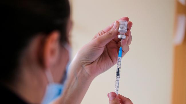 A health workers fills a syringe with a dose of the Pfizer-BioNTech vaccine against COVID-19 at a vaccination centre in Santiago, on July 03, 2021.