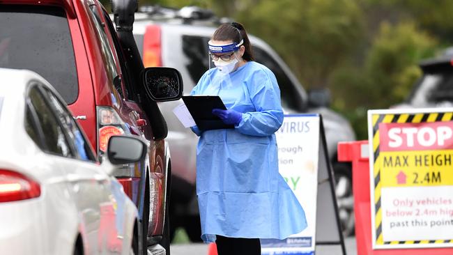 BRISBANE, AUSTRALIA - NewsWire Photos - JULY 1, 2021.A health worker processes arrivals at a COVID-19 drive-through testing station at Murarrie in Brisbane's east. Queensland has gone into a 3-day lockdown due to a recent Covid outbreak.Picture: NCA NewsWire / Dan Peled