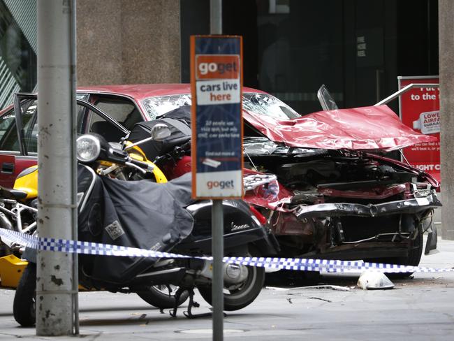 The mangled remains of a pram sit on the wrecked car’s windscreen after the driver is finally halted by police. Picture: David Caird