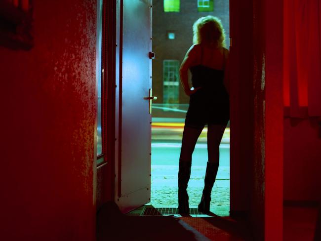 Prostitute Standing in Nightclub Doorway Looking Out. Picture: iSTOCKWomen; Females; Sexual Issues; Brothel; Sex - Single Word; Nightlife; Nightclub; Entertainment Club; Prostitute; Midsection; Adult; Working; Excess; One Person; Sensuality; Desire; Luxury; Red; Blurred Motion; Europe; Night; Door. Generic brothel