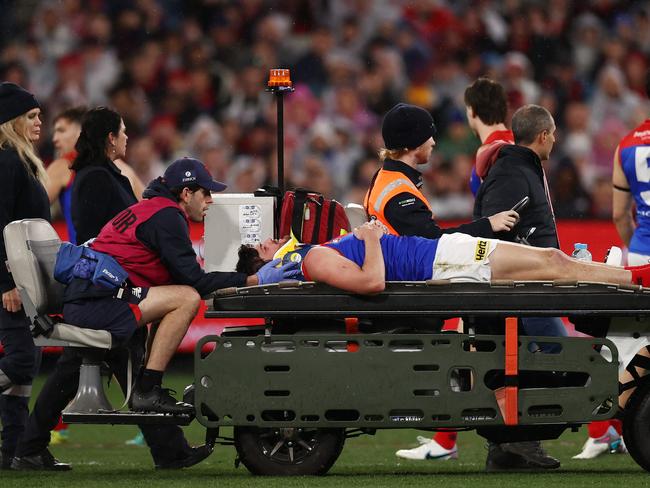 MELBOURNE, AUSTRALIA - August 18, 2023. AFL . 1st Qualifying Final.    Angus Brayshaw of the Demons is stretchered off the ground after being cleaned up by Brayden Maynard of the Magpies   during the qualifying final between Collingwood and Melbourne at the MCG in Melbourne, Australia.  Photo by Michael Klein.