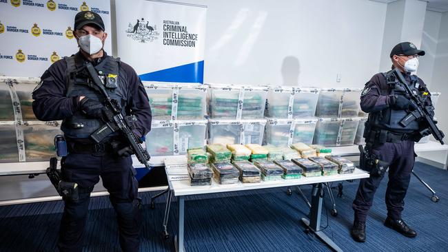 Heavily-armed Australian Federal Police officers with the cocaine shipment, the largest drug bust in SA’s history. Picture: Tom Huntley