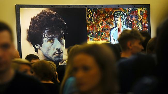 Visitors stand in front of the painting 'Champion Due' by Sylvester Stallone during the art exhibition 'Sylvester Stallone Painting From 1975 Until Today' at the Russian Museum in Saint Petersburg in October last year. 