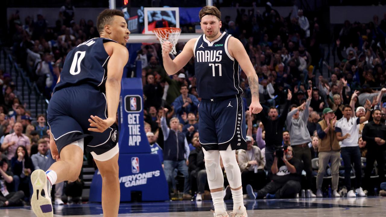 Luka Doncic reacts after a basket by Dante Exum. (Photo by Tim Heitman/Getty Images)