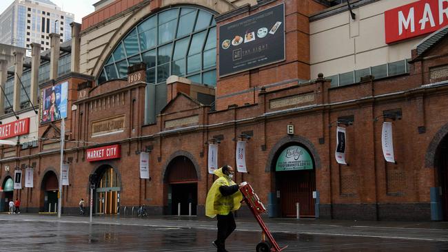 A man wearing a face mask delivers produce through an empty Haymarket in Sydney. Picture: NCA NewsWire/Bianca De Marchi