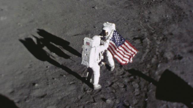 Neil Armstrong places an American flag on the surface of the moon. Picture: NASA.