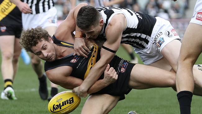 Port’s Joe Atley gets the better of Glenelg’s Matthew Snook Picture: Sarah Reed