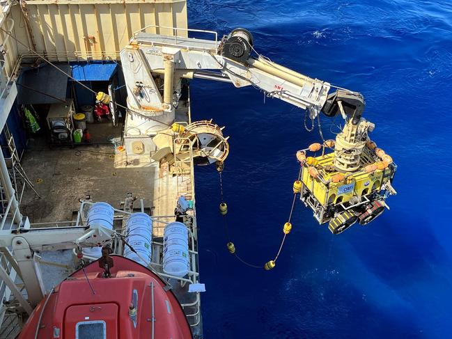 The remotely operated underwater vehicle being lowered off the side of the cable ship Ile de Re to the seabed