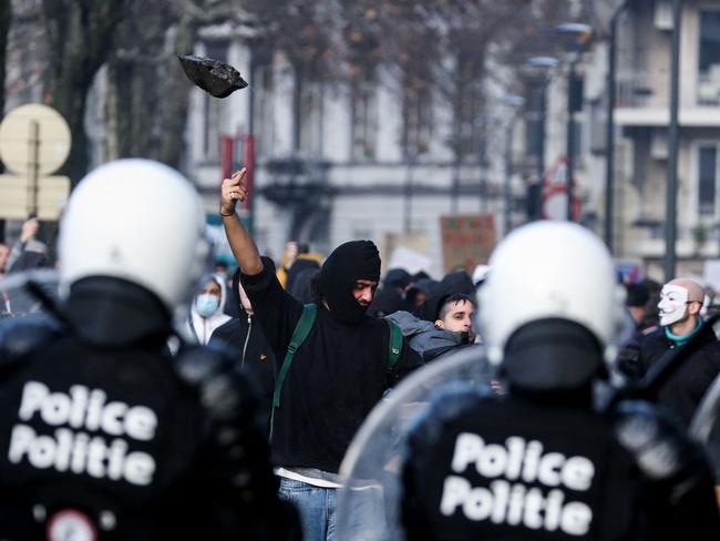 A protester shows a middle finger to riot policemen. Picture: AFP