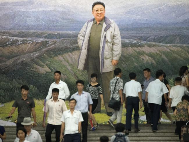 People pass a mural of Kim Jong-il in Pyongyang. Kim Sr used to encourage his people to eat sawdust, claiming it was full of nutrients. Picture: Getty Images