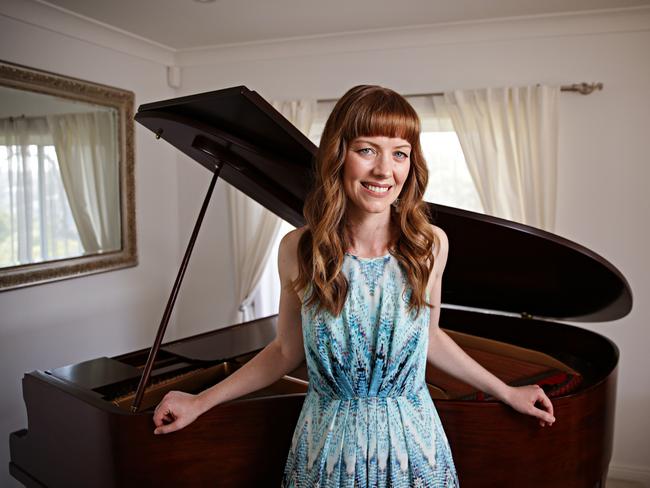 Little at her home in Mosman with the piano her great grandfather bought for her grandmother. Picture: Adam Yip