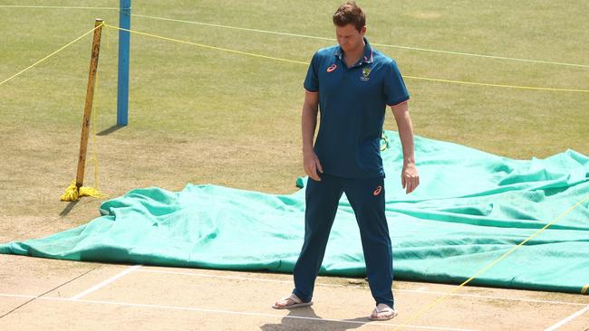 Steve Smith inspects the wicket.