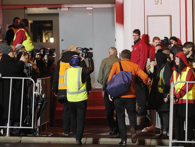 After his emergence from beneath Macquarie St, Mike Parr entered the old <i>Mercury </i>building without a word or any acknowledgment to the crowds that had gathered to see him. Picture: MATHEW FARRELL