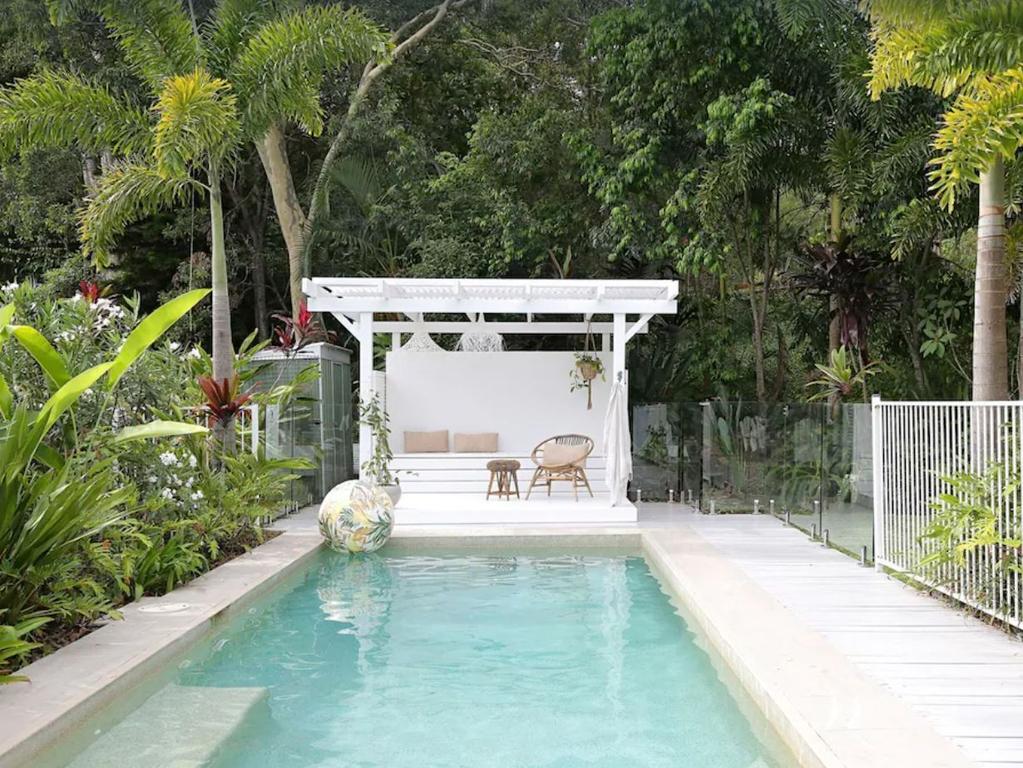 The three bedroom, $829-a-night property sits among a lush tropical garden that features a tranquil pool with a luxe cabana and the huge backyard complete with a cubby house. Picture: Stayz