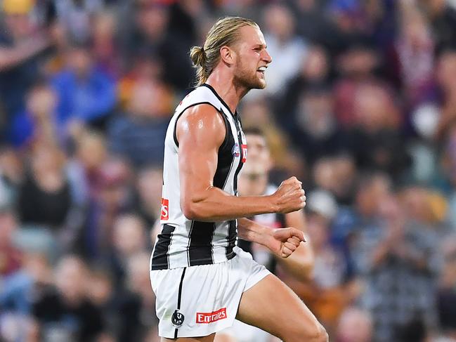 BRISBANE, AUSTRALIA - APRIL 14: Tom Wilson of the Magpies celebrates kicking a goal during the round five AFL match between the Brisbane Lions and the Collingwood Magpies at The Gabba on April 14, 2022 in Brisbane, Australia. (Photo by Albert Perez/AFL Photos/Getty Images)