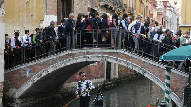 A Tasmania without class warfare or tourism gone mad is our responsibility, not government’s, says Bruce Montgomery. Pictured is a crowded bridge in Venice, Italy. Picture: SUPPLIED