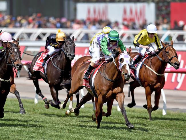 Jockey Michelle Payne (centre) riding Prince Of Penzance crosses the finish line to win the $6,000,000 Melbourne Cup race at Flemington Racecourse in Melbourne, on Tuesday, Nov. 3, 2015.(AAP Image/Julian Smith) NO ARCHIVING, EDITORIAL USE ONLY